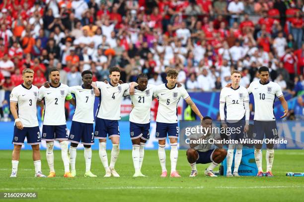 The England side watch on nervously during the penalty shoot out during the UEFA EURO 2024 quarter-final match between England and Switzerland at...