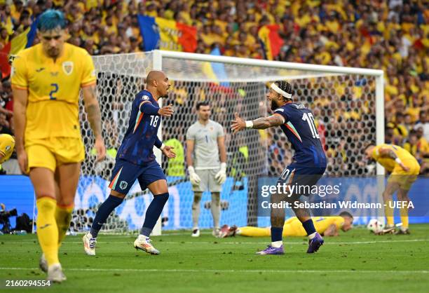 Donyell Malen of the Netherlands celebrates scoring his team's second goal with teammate Memphis Depay during the UEFA EURO 2024 round of 16 match...