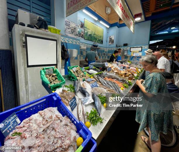 customers at an indoor fish market - fish market french stock pictures, royalty-free photos & images
