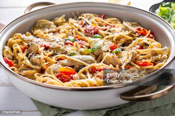 pasta artichoke tomato skillet - artichoke stock pictures, royalty-free photos & images
