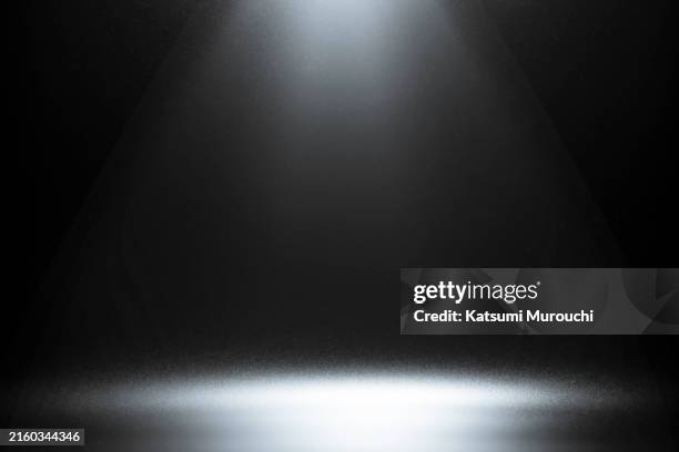 spotlight on studio black wallpaper backdrop - spotlit stock pictures, royalty-free photos & images