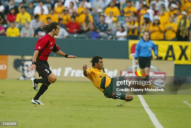 Forward Carlos Ruiz of the Los Angeles Galaxy tries to keep the ball in bounds and away from defender Ryan Suarez of the Dallas Burn during the MLS...