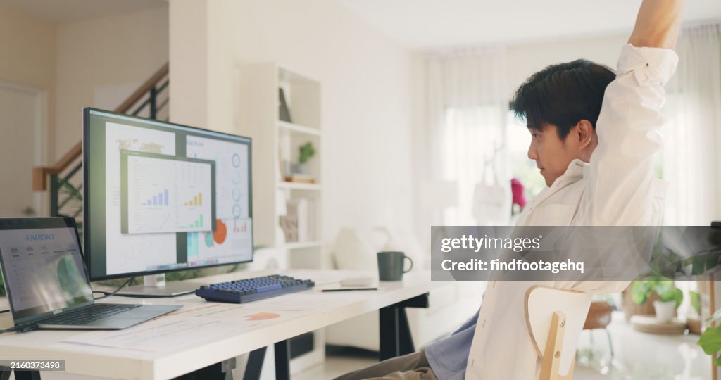 Asian Entrepreneur Taking Break in Home Office.