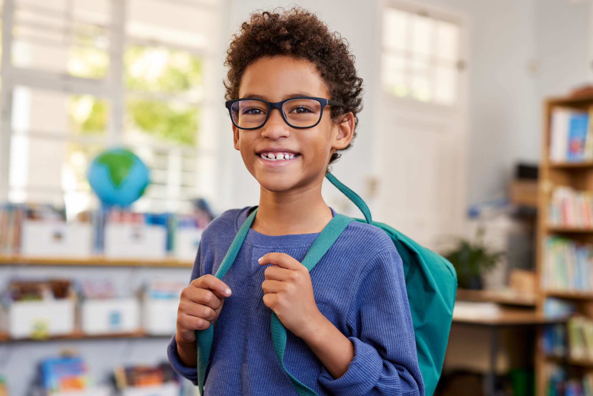 child carrying backpack