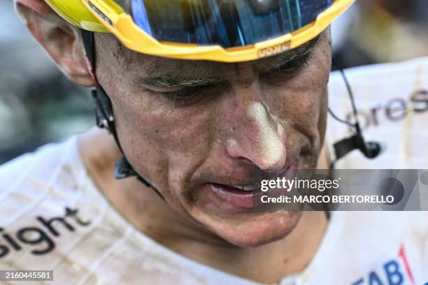 Team Emirates team's German rider Nils Politt look on, his face caked in dust, after the 9th stage of the 111th edition of the Tour de France cycling...