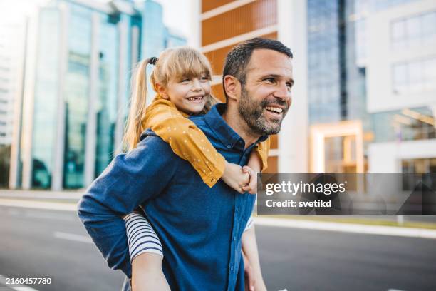 father and daughter walking in the city. - walking city stock pictures, royalty-free photos & images