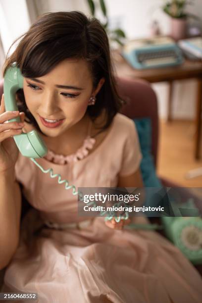 charming woman talking on landline phone - man and machine stock pictures, royalty-free photos & images
