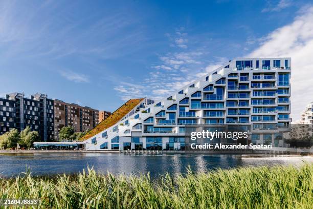 modern apartment buildings by the water in ørestad district, copenhagen, denmark - ørestad stock pictures, royalty-free photos & images