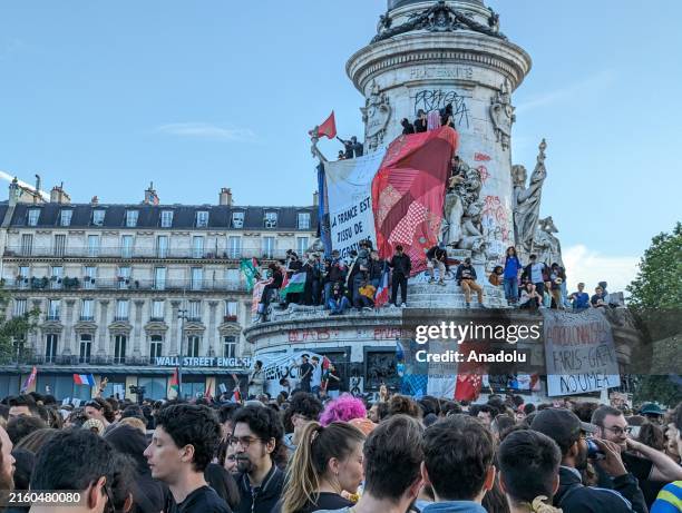 People gather to celebrate the victory of the left-wing union after the partial results of the second round of the French parliamentary elections in...