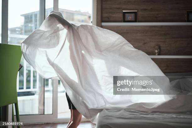 little boy child making bed in morning - fresh from bed stock pictures, royalty-free photos & images