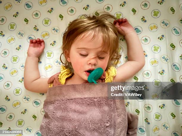toddler napping peacefully - pacifier stock pictures, royalty-free photos & images