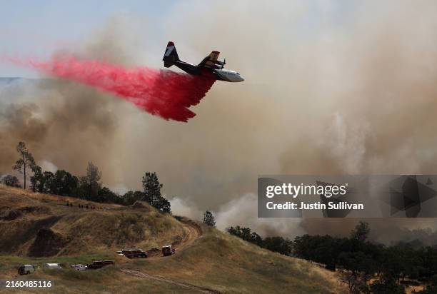 Firefighting aircraft drops Phos-Chek fire retardant ahead of the Thompson Fire on July 03, 2024 in Oroville, California. At least 12,000 Butte...