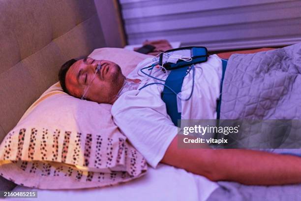 man being tested for sleep apnea - sleep study stock pictures, royalty-free photos & images