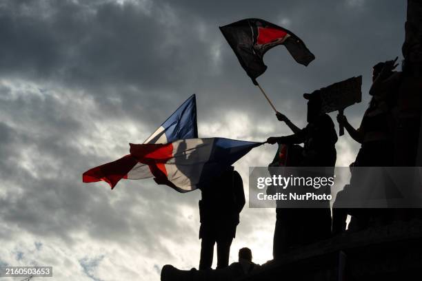 People are gathering and celebrating during an election night event following the first results of the second round of France's legislative election...