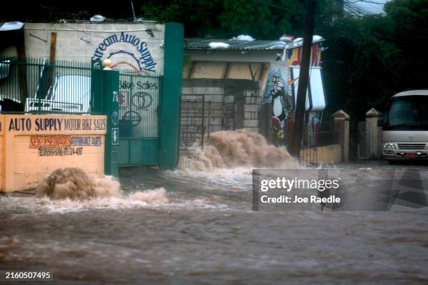 Flood waters pour onto the street as Hurricane Beryl passes through the area on July 03 in Kingston, Jamaica. Beryl has caused widespread damage in...