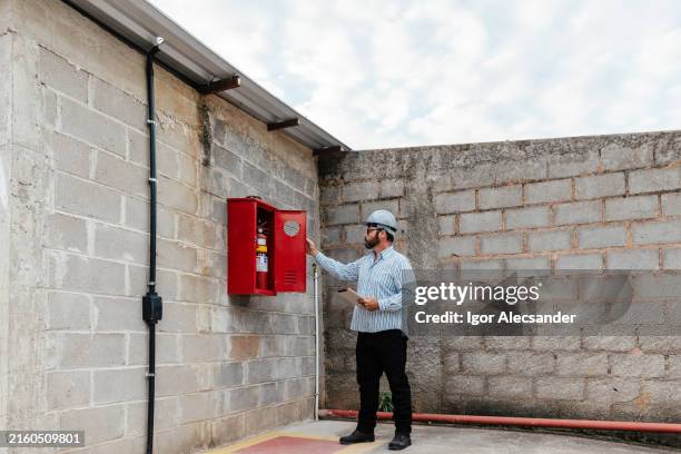 inspector checking installation and fire fighting standards - scrutiny stock pictures, royalty-free photos & images