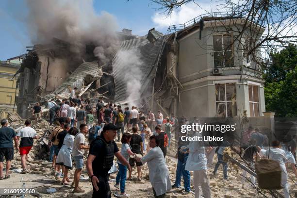 People search for victims after the Russian army launched a rocket attack on the "Ohmatdyt" children's clinic on July 8, 2024 in Kyiv, Ukraine....