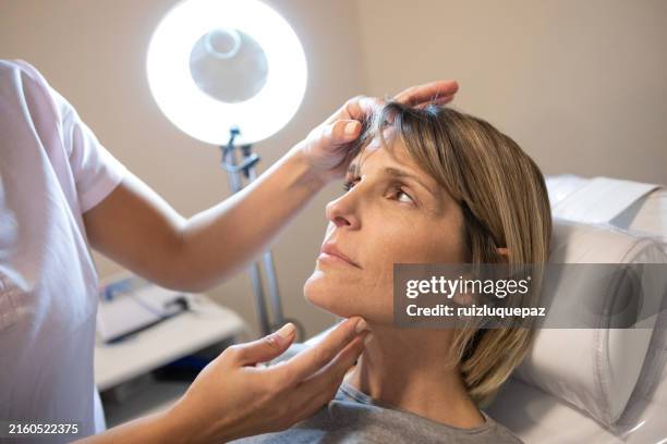dermatologist and esteticien in consultation with female patient - tratamento de beleza ocupação imagens e fotografias de stock