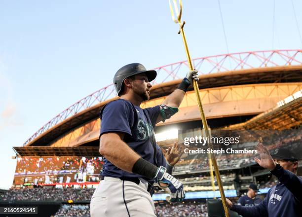 Cal Raleigh of the Seattle Mariners celebrates his home run with the trident during the sixth inning against the Baltimore Orioles at T-Mobile Park...
