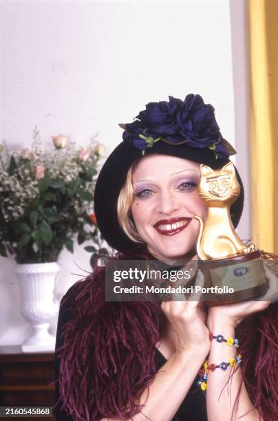 The American singer-songwriter Madonna poses smiling with the Telegatto. Italy, 1992
