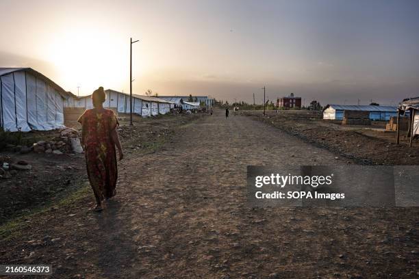 Woman walks through a long dirt road inside the largest refugee camp in Mekele. The war in Tigray, Ethiopia, which pitted the TPLF against the...