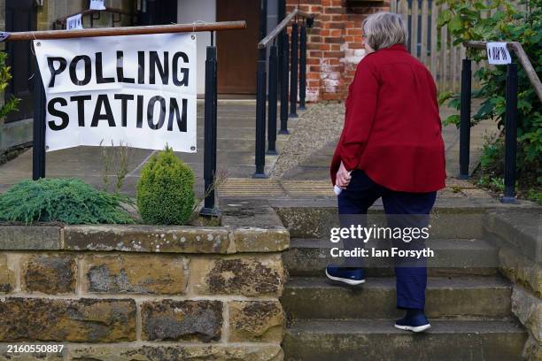 Woman enters a polling station to cast her vote in the general election on July 04, 2024 in Ingleby Cross, United Kingdom. Voters in 650...