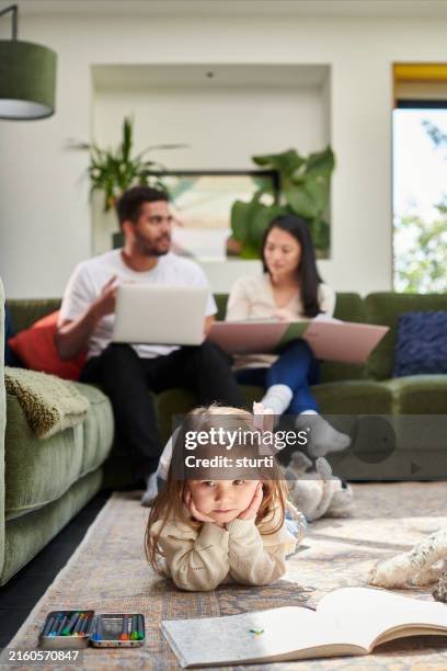 little girl is bored as mum and dad are busy - ignoring stock pictures, royalty-free photos & images
