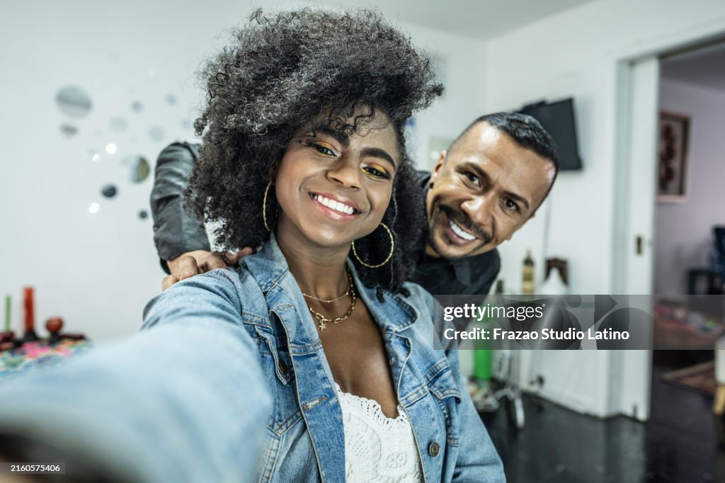 Young woman and beautician taking a selfie or filming on beauty saloon - camera point of view