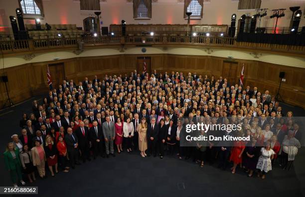 New UK Prime Minister Sir Keir Starmer stands with Labour Party MPs, including some who won seats in the recent general election, at Church House in...