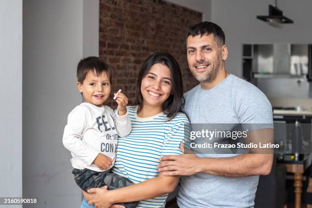 portrait of a family at home - hispanic family portrait stock pictures, royalty-free photos & images