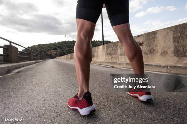 triathlete training leg strength and running on a bridge - calf stock pictures, royalty-free photos & images