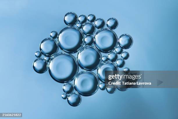 macrophotography of many various oil bubbles on the surface of water. abstract natural backdrop with copy space - translucide photos et images de collection