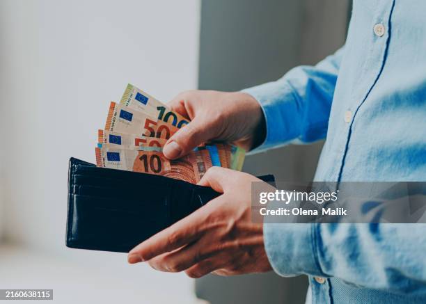 man taking money out of wallet, european currency - european union stock pictures, royalty-free photos & images