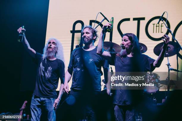 Guthrie Govan, Marco Minnemann and Bryan Beller of The Aristocrats, an experimental and progressive rock band, cheers with a beer at the final of...