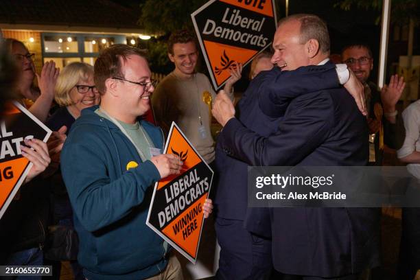 Liberal Democrat supporters greet Sir Ed Davey as he arrives at the results of his constituency's vote count during the UK general election on July...