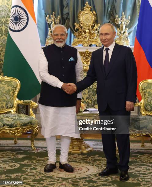 Russian President Vladimir Putin greets Indian Prime Minister Narendra Modi during their bilateral meeting at the Grand Kremlin Palace, on July 9,...