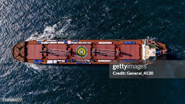 aerial top view large general cargo ship bulk carrier running hi-speed in the deep sea. - bulk carrier stock pictures, royalty-free photos & images