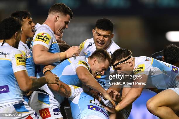 Titans celebrate a Keenan Palasia try during the round 18 NRL match between Cronulla Sharks and Gold Coast Titans at Coffs Harbour International...