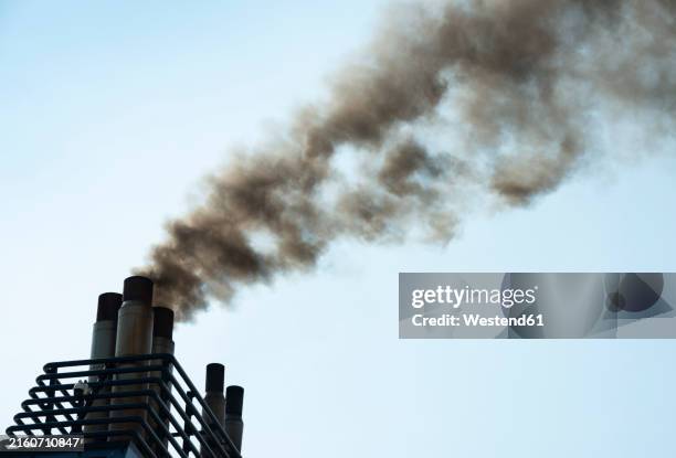 smoke stack on ship emitting poisonous gas under sky - emitting stock pictures, royalty-free photos & images