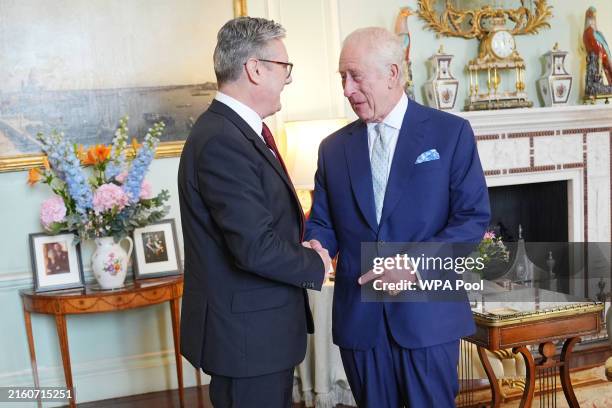 King Charles III welcomes Sir Keir Starmer during an audience at Buckingham Palace, where he invited the leader of the Labour Party to become Prime...
