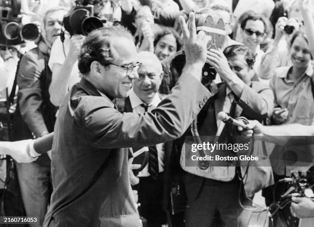 William Sloane Coffin throws up the peace sign as he enters the Federal Building for sentencing on July 10, 1968. Coffin and three other codefendants...