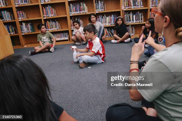 Los Angeles, CA Students play a game inside the library during an Los Angeles Unified School District free summer program at Monte Vista Street...