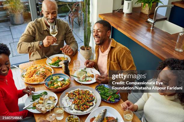 family gathering at home for reunion dinner - lounge dinner stock pictures, royalty-free photos & images