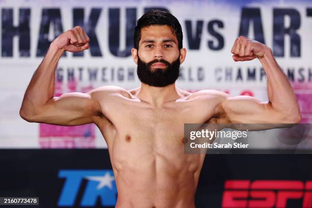 Miguel Madueno of Mexico poses on the scale during a weigh-in ahead of their Lightweight bout against Keyshawn Davis at Prudential Center on July 05,...