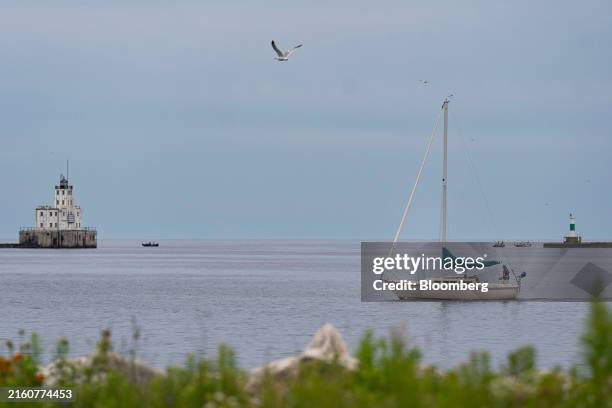 Sail boat passes the Milwaukee Breakwater Light ahead of the Republican National Convention in Milwaukee, Wisconsin, US, on Tuesday, July 9, 2024....