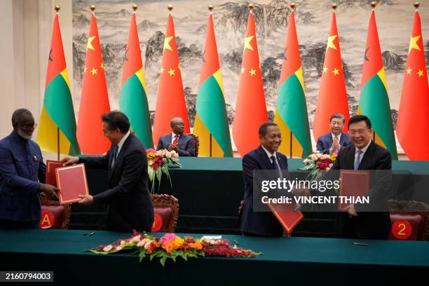 China's President Xi Jinping and Guinea-Bissau's President Umaro Sissoco Embalo applaud during a signing ceremony at the Great Hall of the People in...