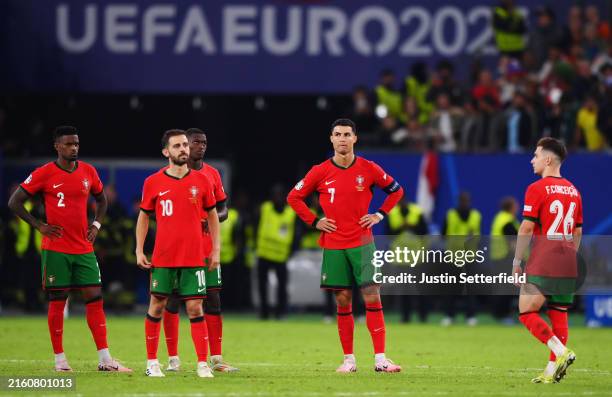 Nelson Semedo, Bernardo Silva, Cristiano Ronaldo and Francisco Conceicao of Portugal look dejected after defeat to France in the Penalty Shootout...
