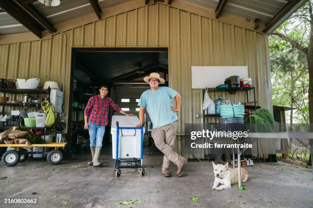 farm workers portrait in farm building - farm worker stock pictures, royalty-free photos & images