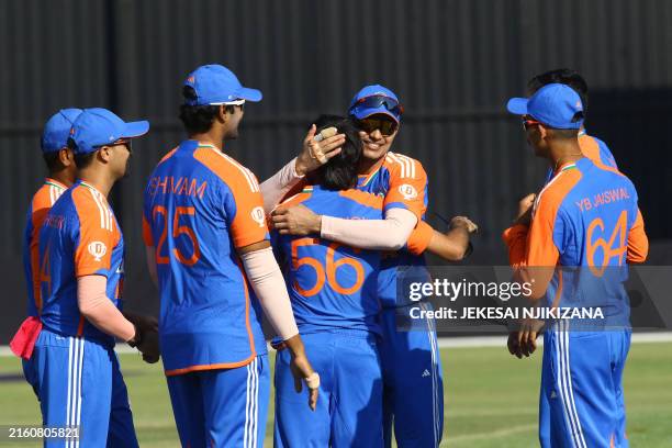 India's Ravi Bishnoi celebrates with teammates after a dismissal during the third T20 international cricket match between Zimbabwe and India at...