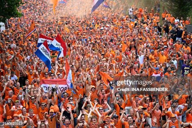 Dutch fans cheer in the streets of Dortmund, western Germany, on July 10, 2024 prior to the UEFA Euro 2024 semi-final football match Netherlands v...